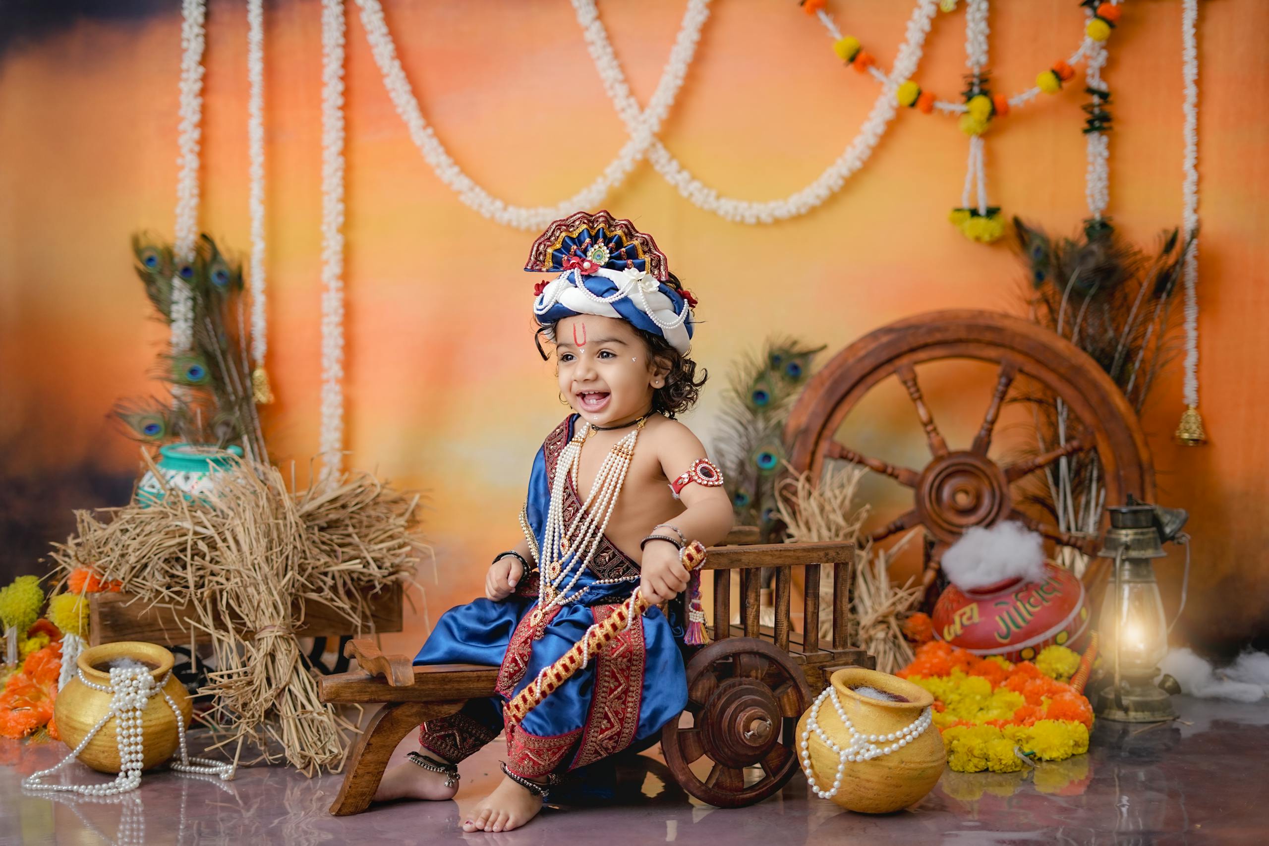 Charming photo of a child dressed as Krishna with festive decorations, perfect for ethnic celebrations.